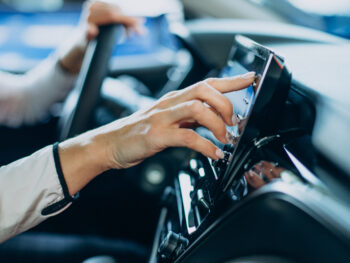 Woman touching screen in her car
